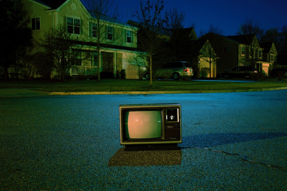 old TV in road